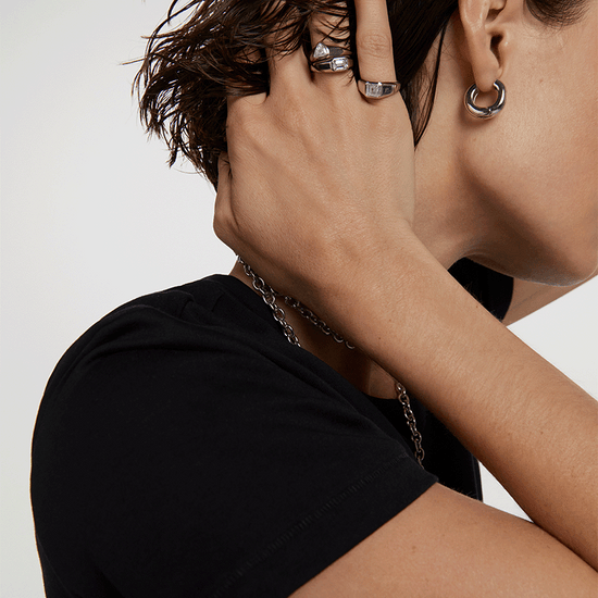 Lady with black shirt and silver jewellery.